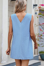 VYSN V-neck sleeveless denim dress hanging on a mannequin, showcasing casual summer fashion with front pockets and a fitted waist.