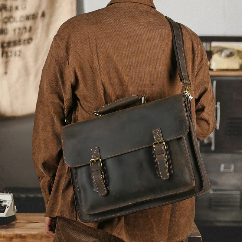 Leather one-shoulder crossbody laptop bag with top layer design, featuring a sleek Plush Fashion Hub style and a spacious interior.