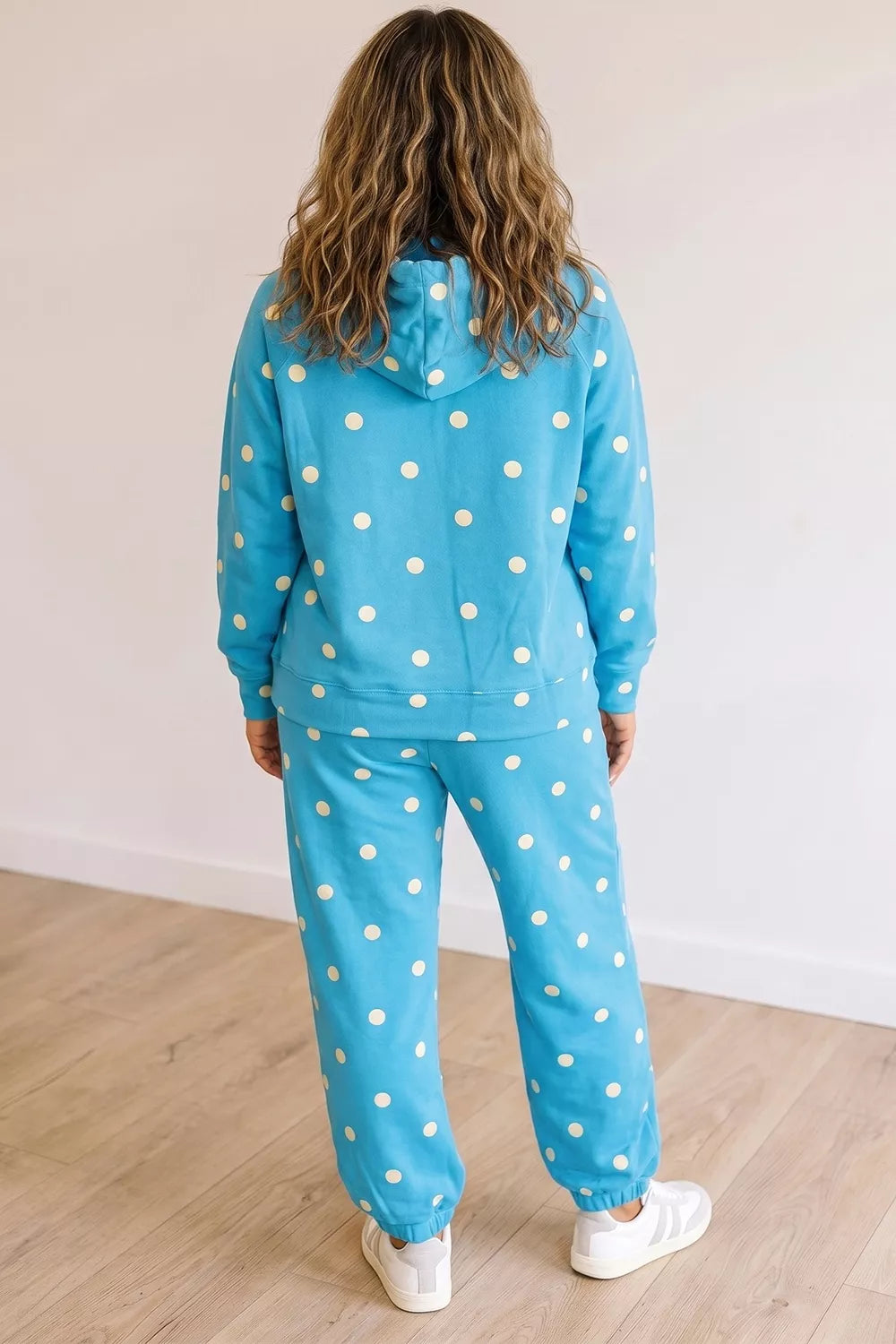 Plus size polka dot hooded long sleeve top and matching pants set from Trendsi, featuring a drawstring hoodie and comfortable fit.