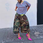 Women's wide-leg cargo pants by Plush Fashion Hub featuring zipper and button details, with deep pockets and relaxed fit.