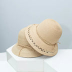 Woven straw bucket hat with decorative band by Plush Fashion Hub, featuring a wide brim and stylish woven design.
