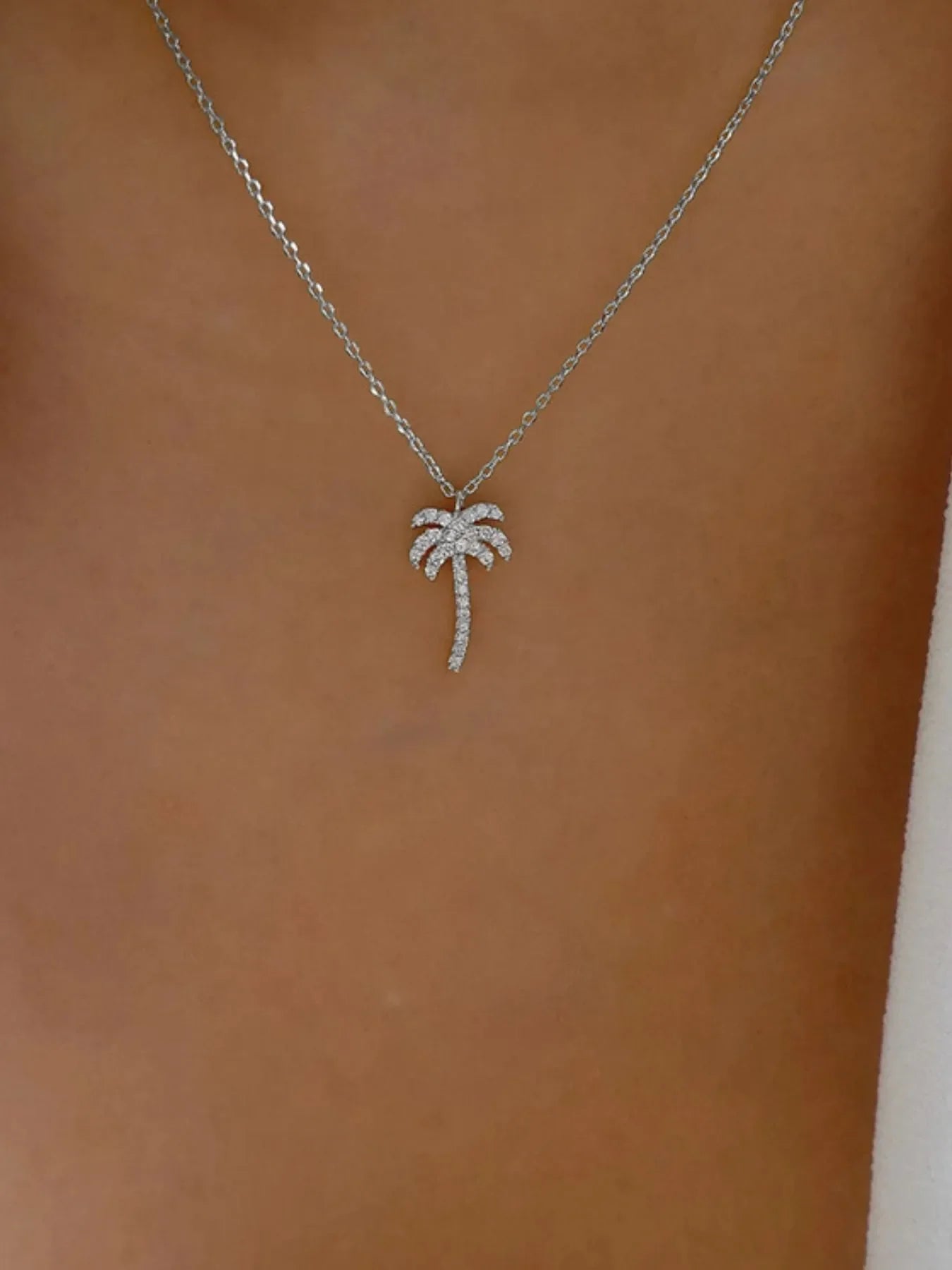 Zircon Palm Tree Pendant Necklace featuring a sparkling palm tree charm on a delicate chain, jewelry by Plush Fashion Hub