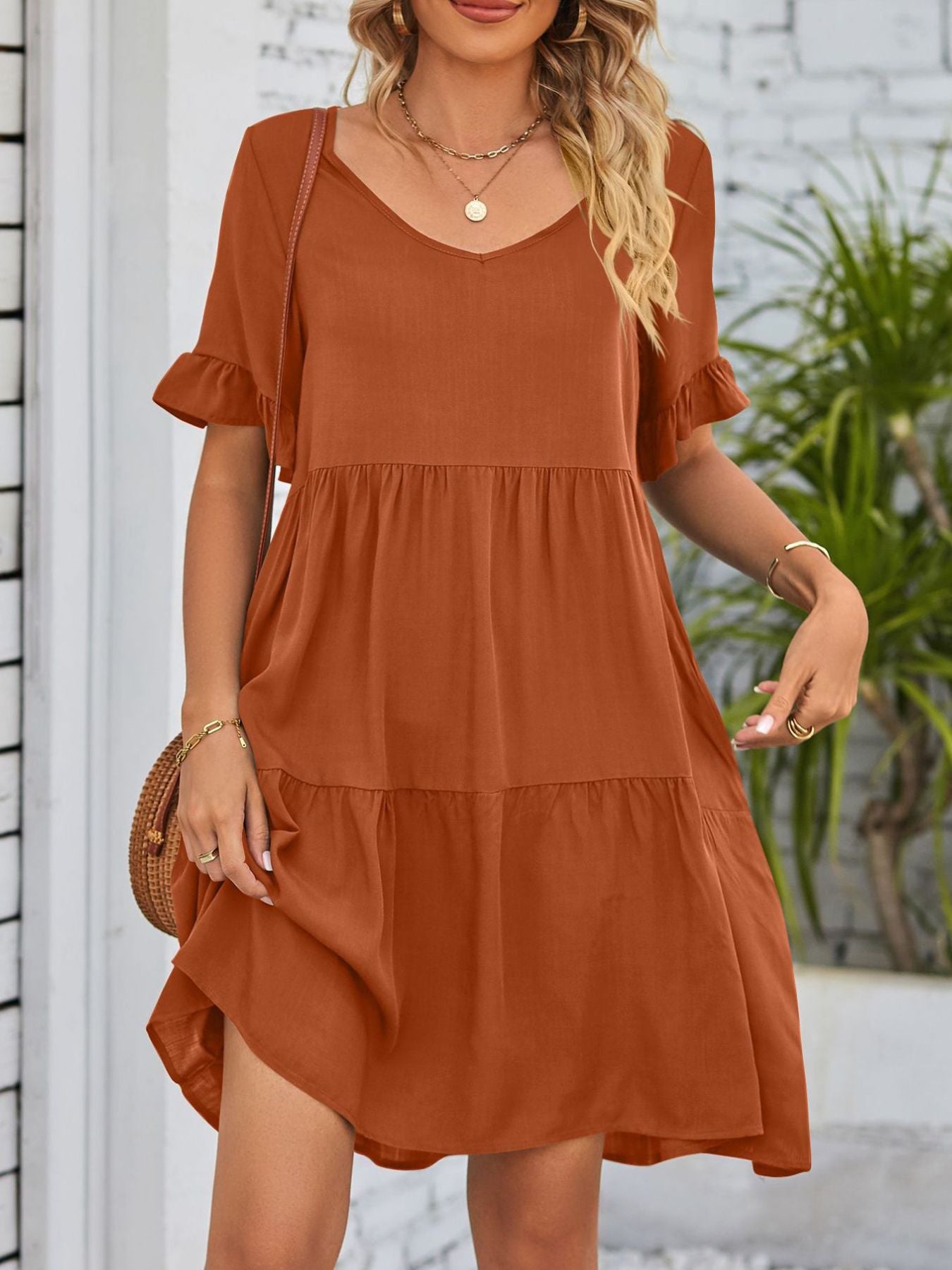 Lightweight rayon ruffled sleeve tiered mini dress with pockets, stylish and feminine, perfect for casual or summer wear.