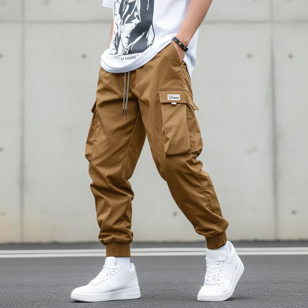 Men's streetwear cargo pants with multiple pockets and drawstring waist by Plush Fashion Hub, shown in a casual style.