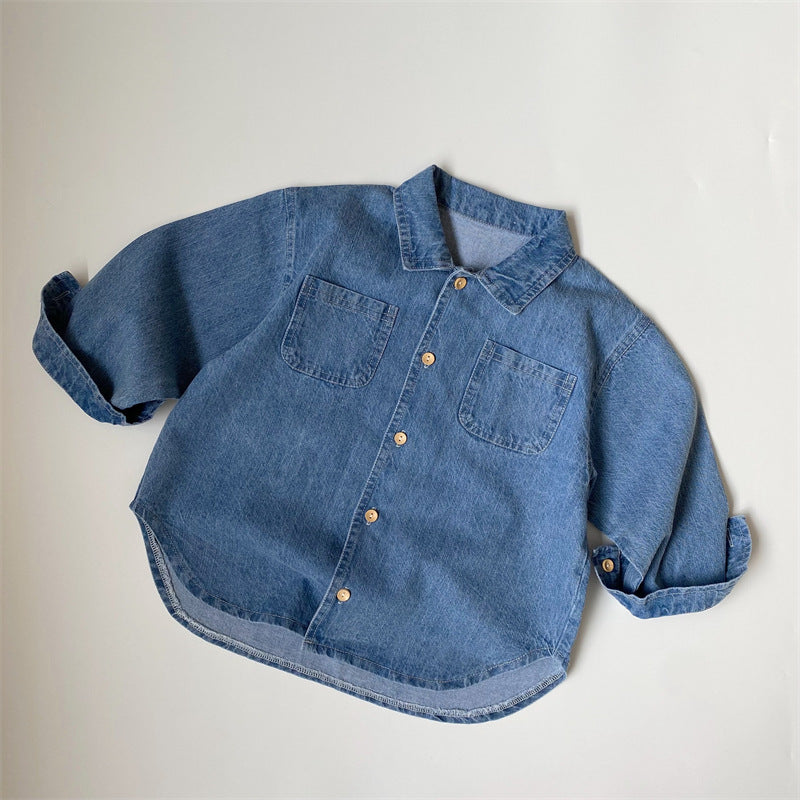 Blue denim shirt with long sleeves, collar, front buttons, and two chest pockets.