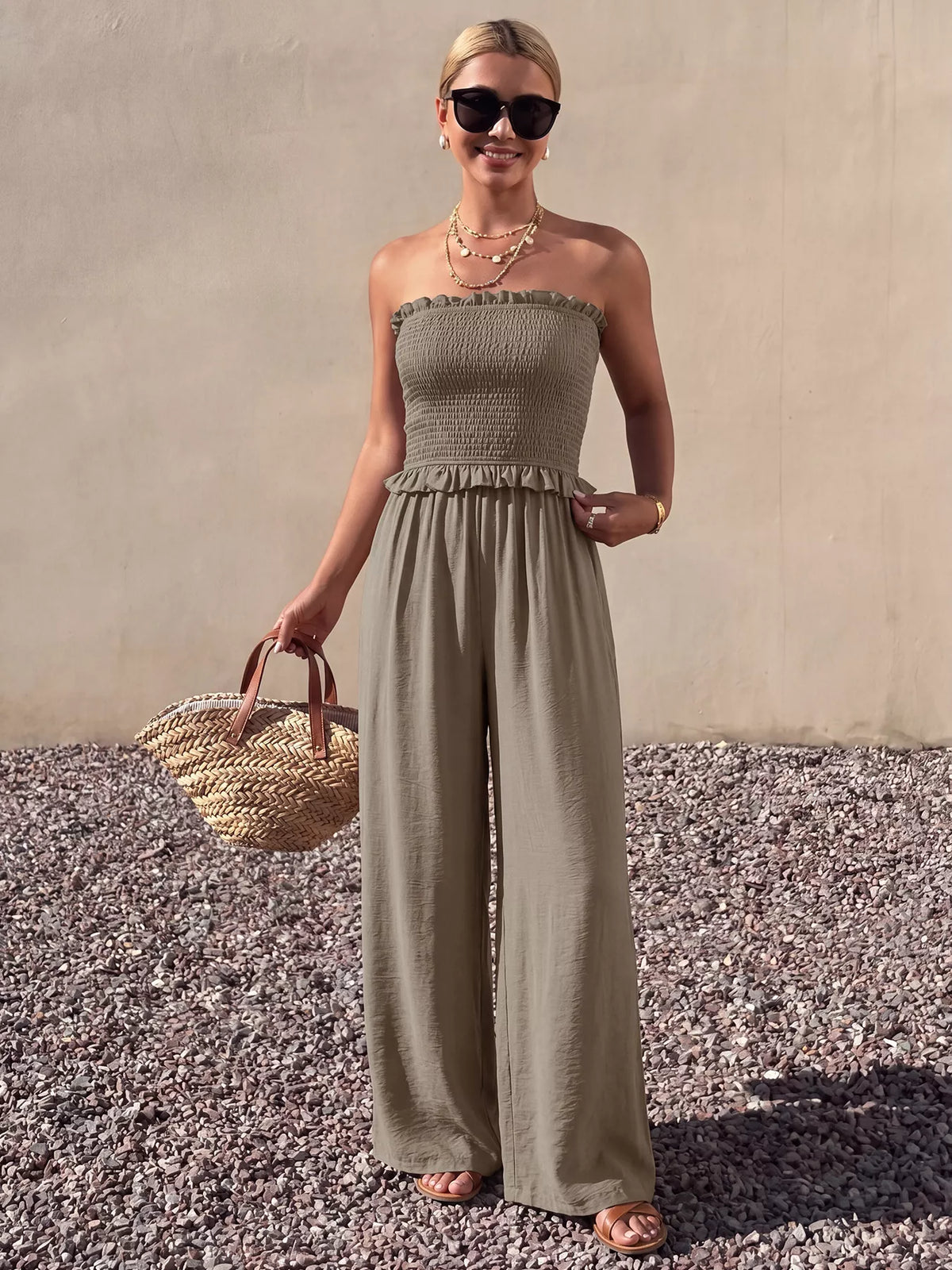 Plush Fashion Hub smocked strapless wide-leg jumpsuit, stylish and comfortable, shown in a flat-lay image with soft fabric details.