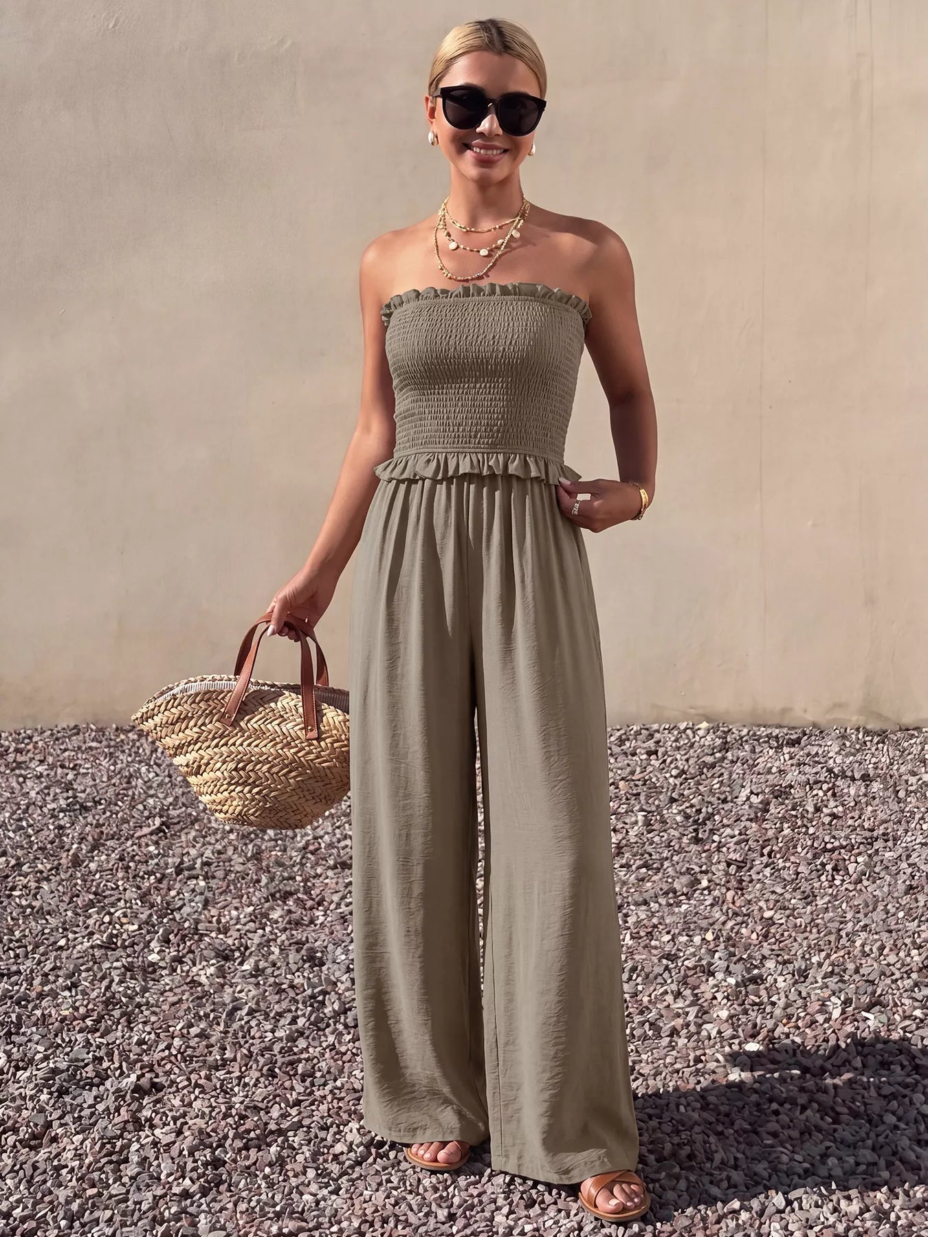 Plush Fashion Hub smocked strapless wide-leg jumpsuit, stylish and comfortable, shown in a flat-lay image with soft fabric details.