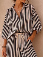 Plus size striped puff sleeve shirt and wide-leg drawstring pants set by Trendsi, featuring a coordinated full-length top and pants.