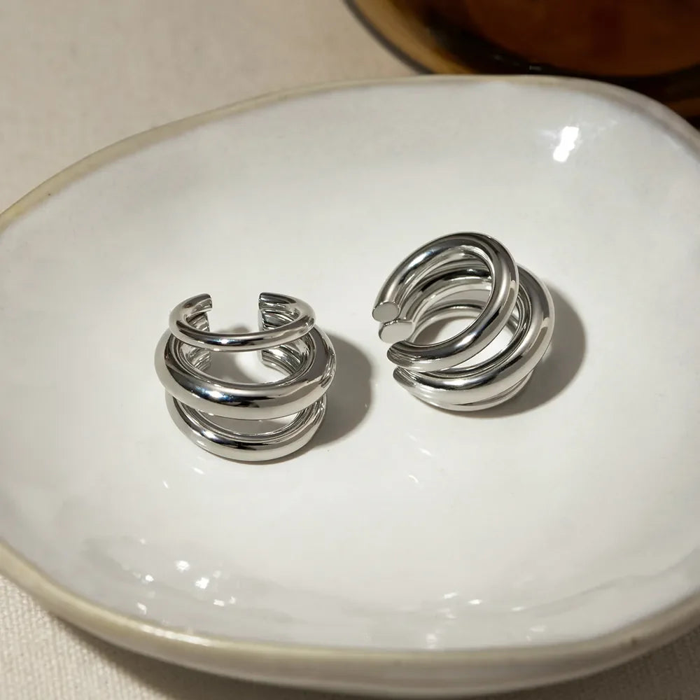 Stainless steel layered cuff earrings with a sleek, modern design, perfect for fashion-forward accessories.