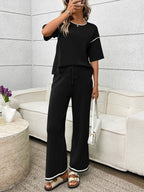 Women's casual two-piece lounge set with round neck top and drawstring pants by Trendsi, shown in a relaxed fit.
