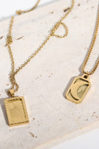 Stainless steel 18K gold-plated necklace with a sleek, polished finish, displayed on a neutral background.