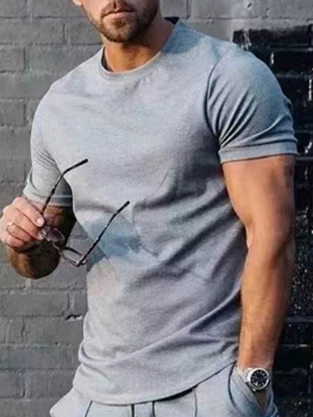 Plus size men's solid color casual T-shirt from Trendsi, showing a comfortable fit and simple design in a natural pose.
