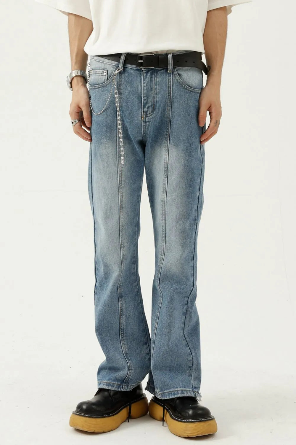 Raw hem denim jeans with pockets by Trendsi, showcasing distressed edges and classic five-pocket design on a casual model.