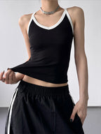 Black contrast trim cami top from Trendsi featuring thin straps and a fitted silhouette, ideal for casual or layered outfits.