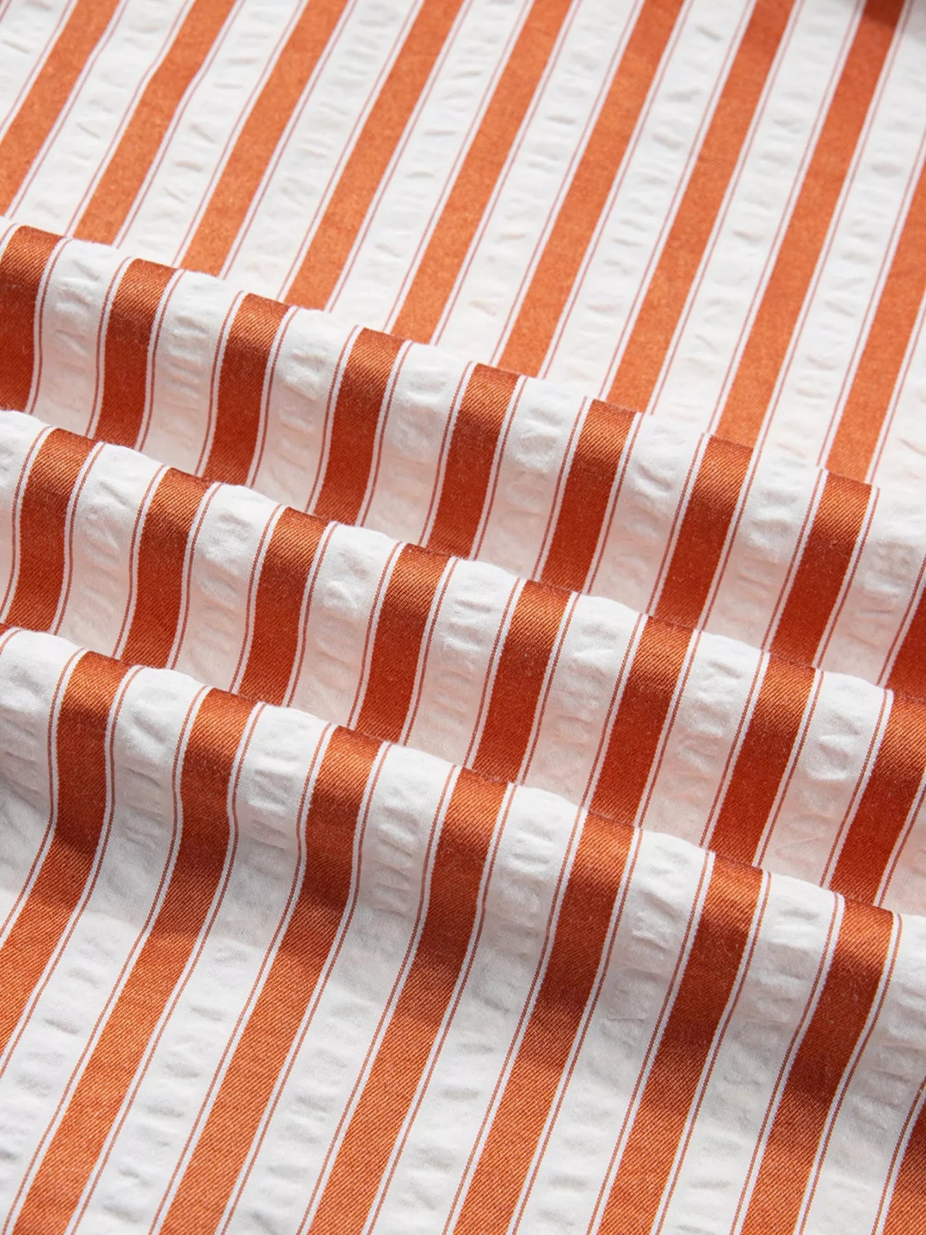 Stripe pinched V-neck mini dress with turn-up cuffs and pockets by Plush Fashion Hub, featuring a stylish striped pattern and fitted silhouette.