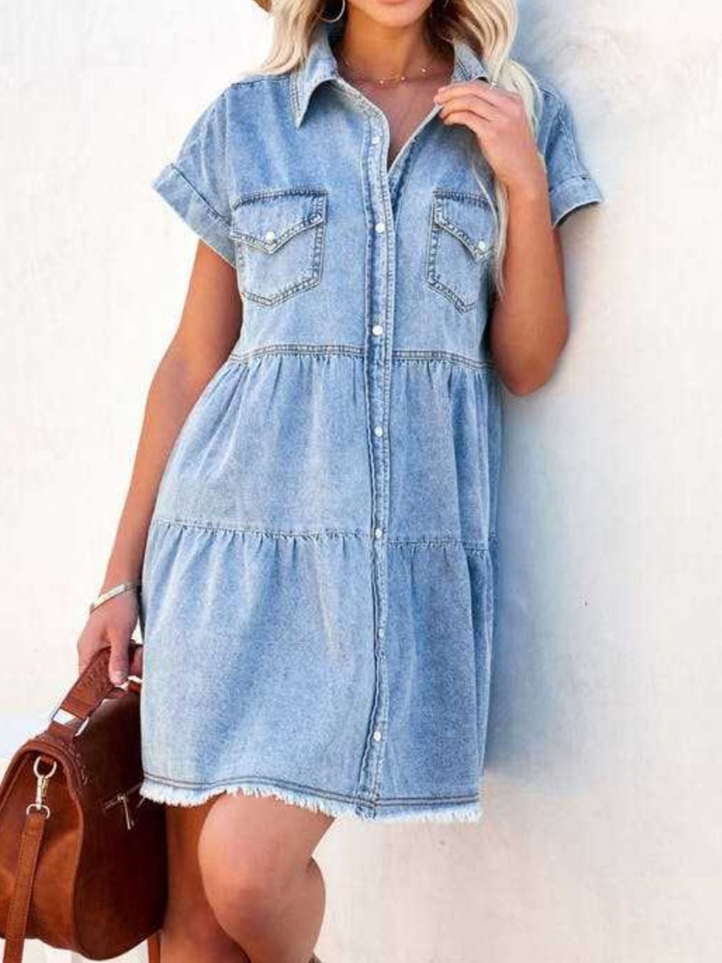 VYSN raw hem short sleeve denim dress hanging on a mannequin, showcasing casual fashion with distressed details and a relaxed fit.