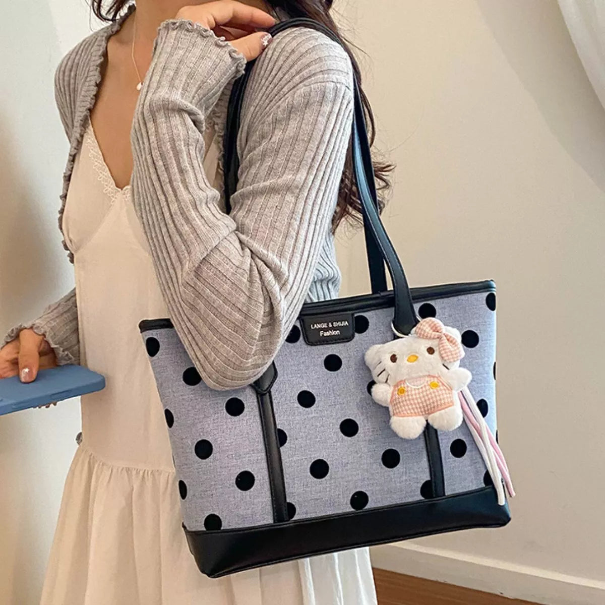 Polka dot women's shoulder handbag by Trendsi featuring a stylish, compact design with a shoulder strap and polka dot pattern.