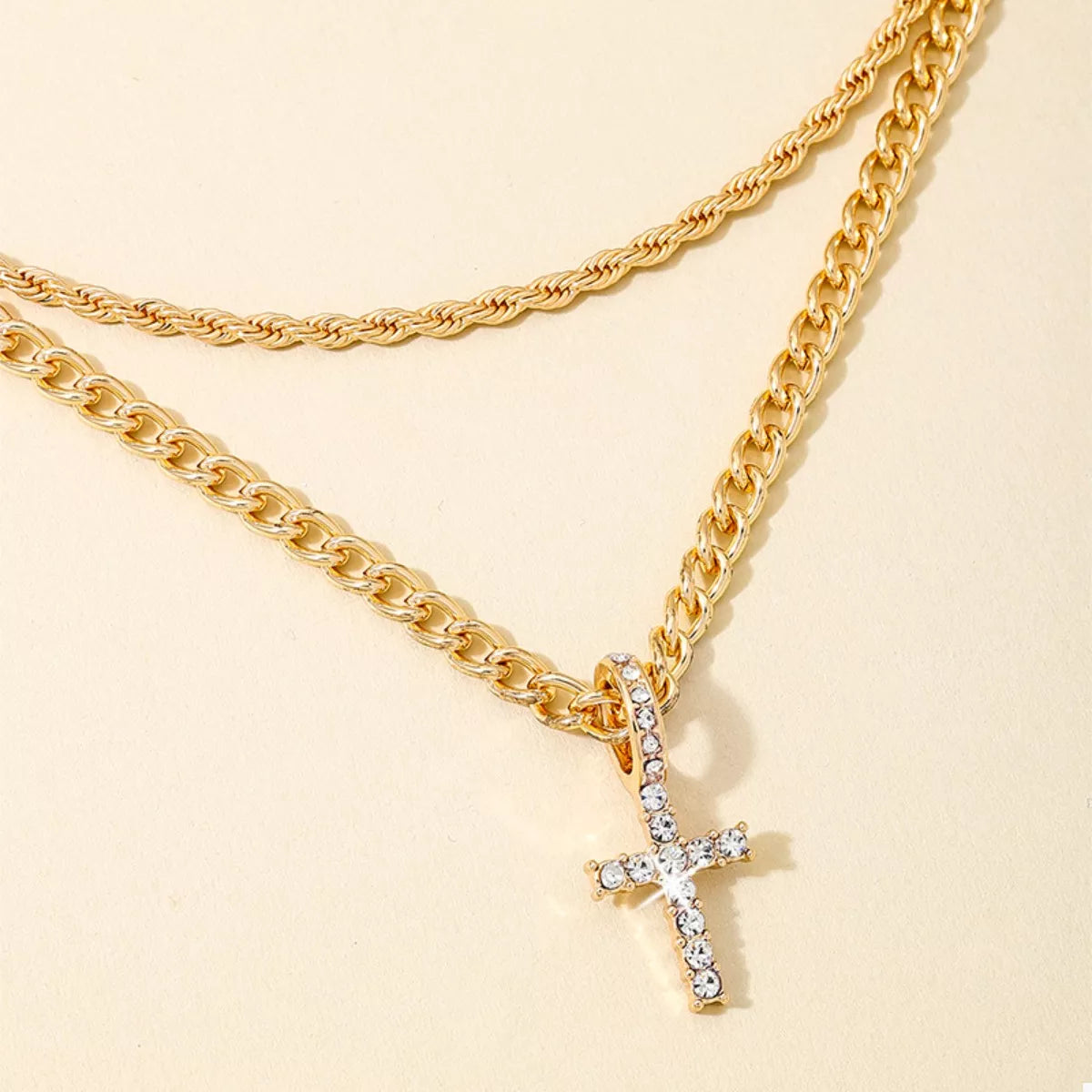 Layered gold chain cross pendant necklace featuring multiple chains and a cross charm, stylish jewelry by Plush Fashion Hub.