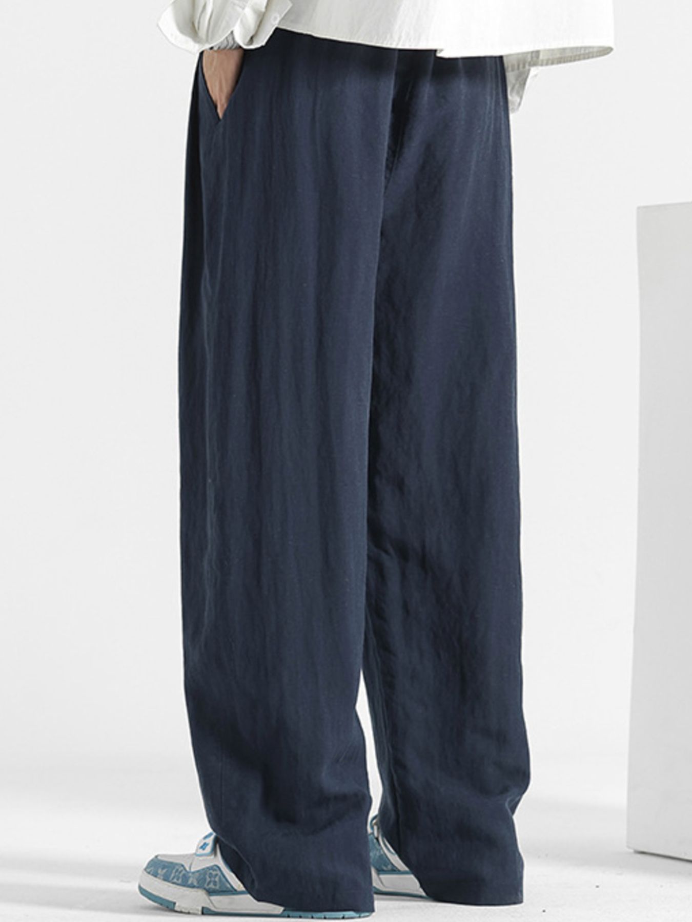 Men's casual loose fit pocket pants from Trendsi with comfortable stretch fabric, relaxed fit, and functional front and back pockets.