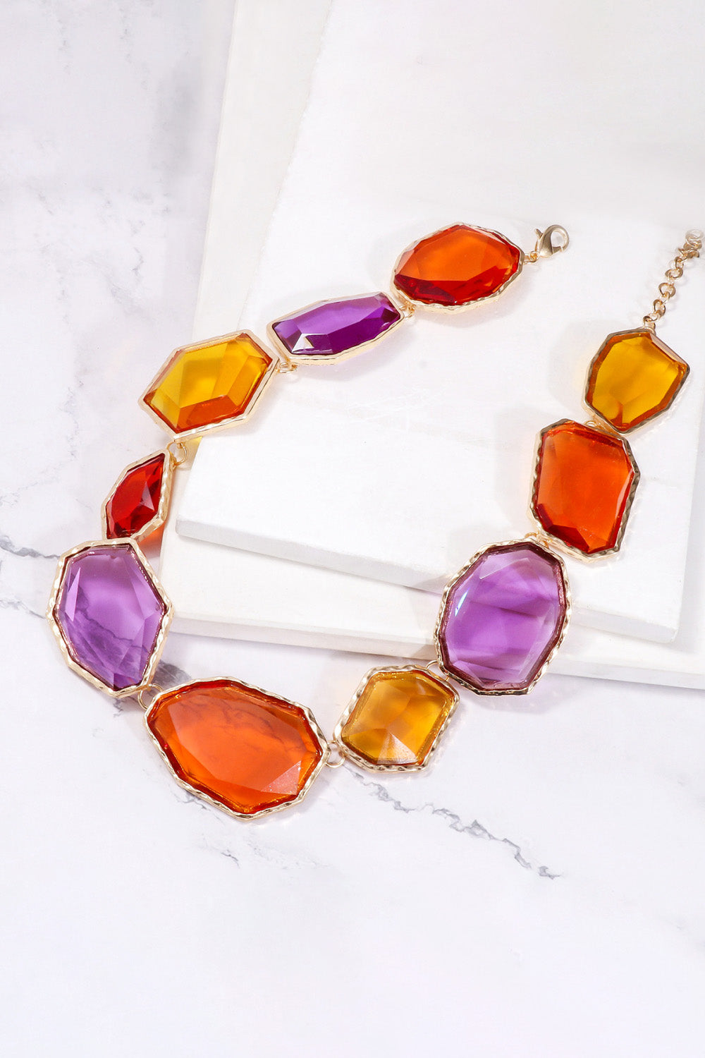 Geometrical shape resin necklace with zinc alloy frame, featuring modern design and vibrant colors, from Plush Fashion Hub.