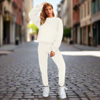 Women's solid color round neck sweatshirt and pants set by Plush Fashion Hub, casual wear with a relaxed fit and comfortable fabric.