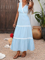 Striped sleeveless tiered midi dress by Trendsi showcasing a flowy, tiered design with bold horizontal stripes.