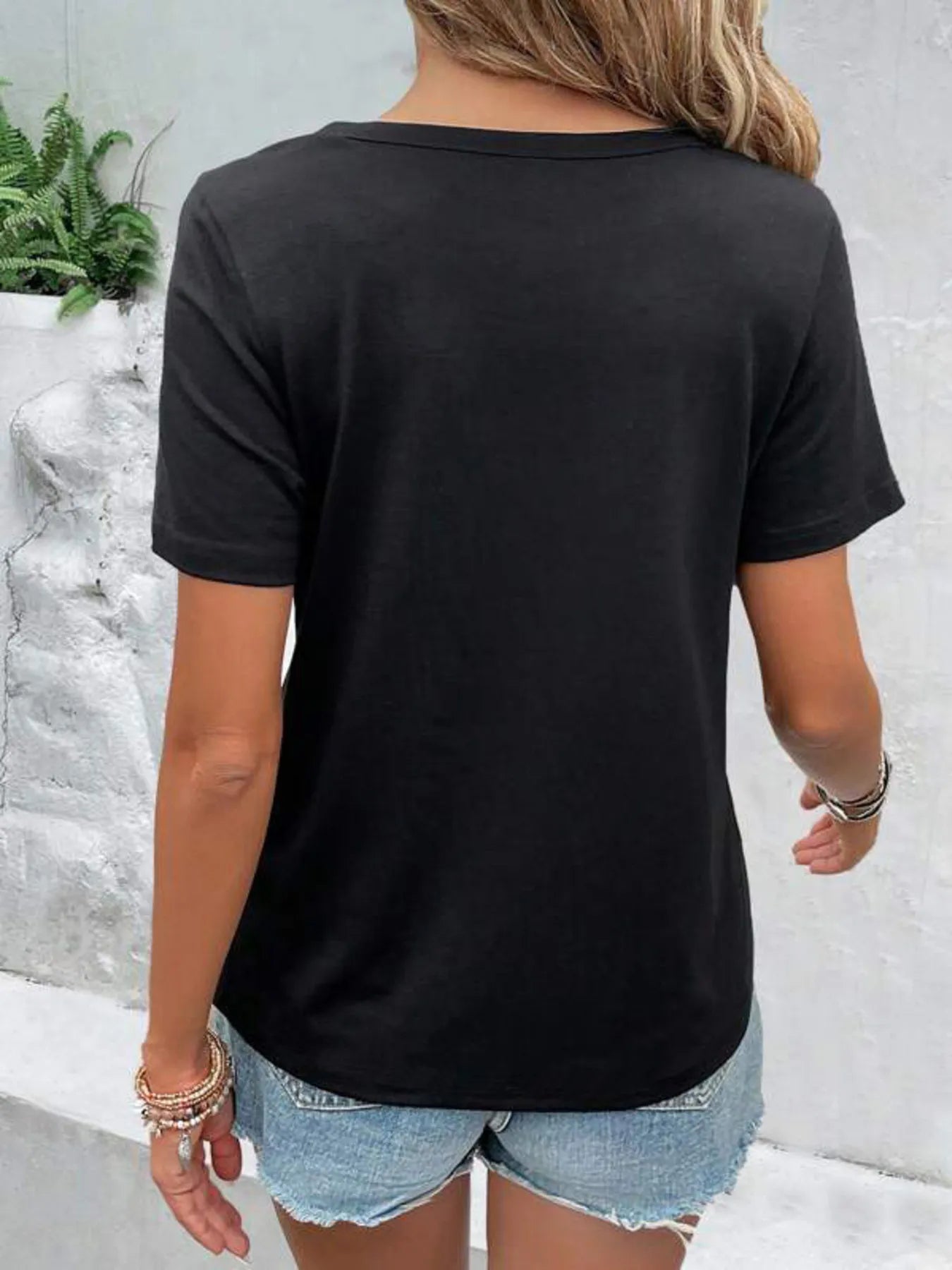 White hollow out neckline short sleeve T-shirt from Trendsi, featuring a stylish cutout design on the neckline.