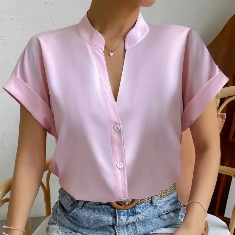 Light orange satin V-neck short sleeve shirt for women, casualwear from Plush Fashion Hub, displayed on a neutral background.