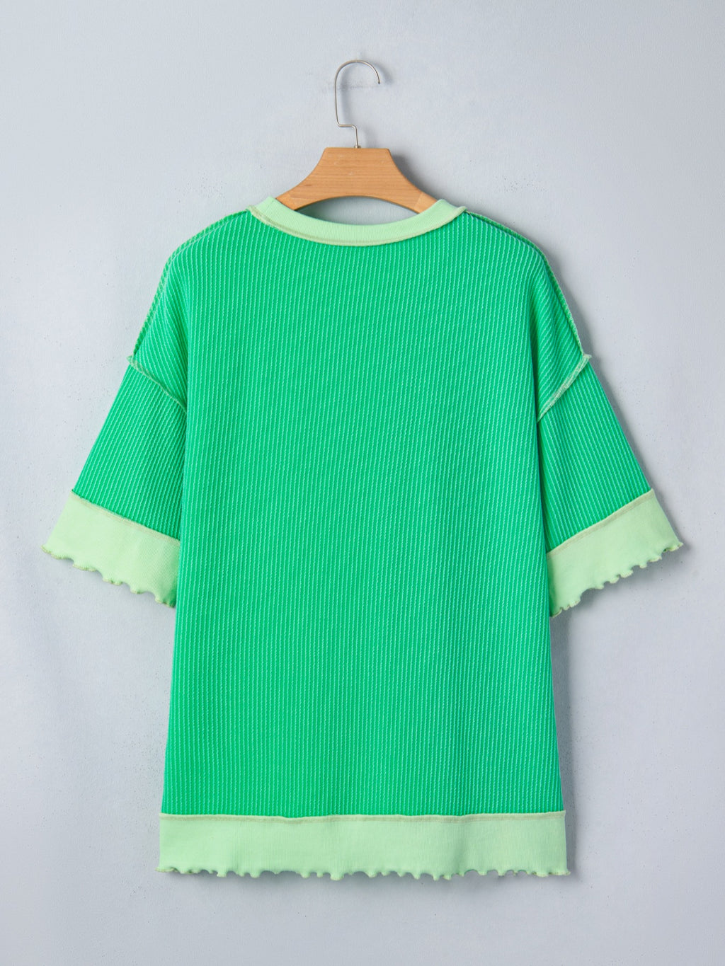 Women's ribbed twist hem short sleeve T-shirt with contrast stitching, featuring a fitted design and stylish neckline.