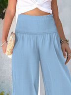Women's wide-leg casual trousers with smocked waist, lightweight and comfortable, by Trendsi, shown in beige fabric.