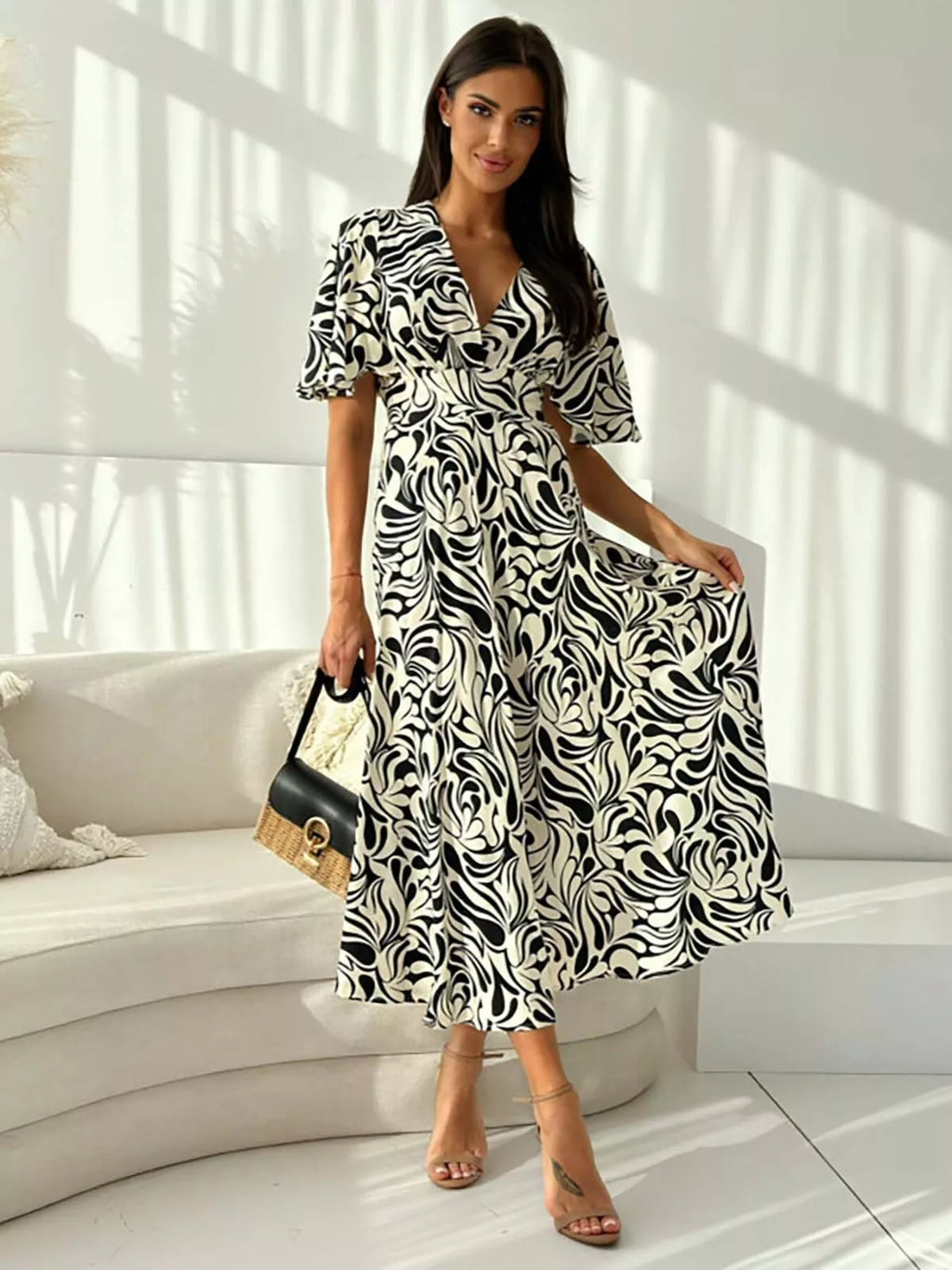 Printed flutter sleeve midi dress by Shopimist featuring a flowy silhouette and vibrant floral pattern.