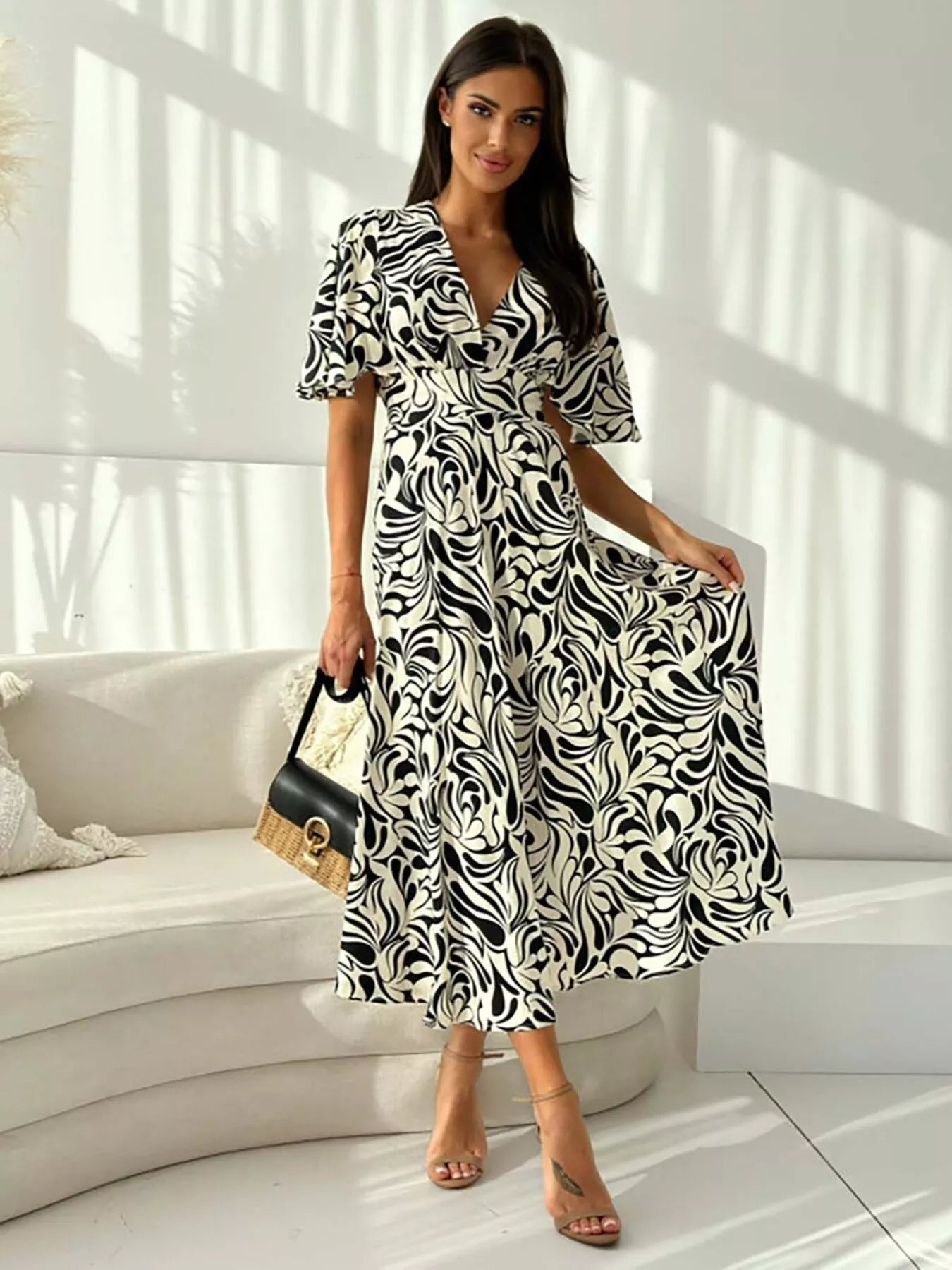 Printed flutter sleeve midi dress by Shopimist featuring a flowy silhouette and vibrant floral pattern.