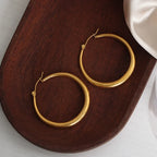 18K gold-plated hoop earrings with a sleek, polished finish, showcasing classic hoop design on a plain background.