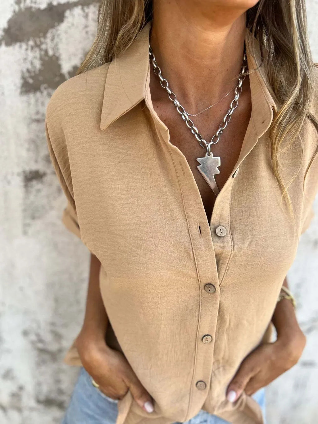 Women's collared half sleeve button-down blouse by Trendsi, featuring a sophisticated office-ready design in a stylish top.