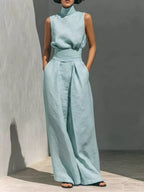 Sleeveless turtleneck top and wide-leg pants set by Trendsi, featuring a fitted turtleneck and flowing wide-leg trousers.