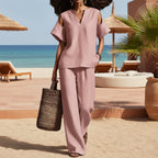 FitiqueFit v-neck short sleeve top and straight-leg pants set with ripped details, pockets, in a solid color, two-piece casual outfit.