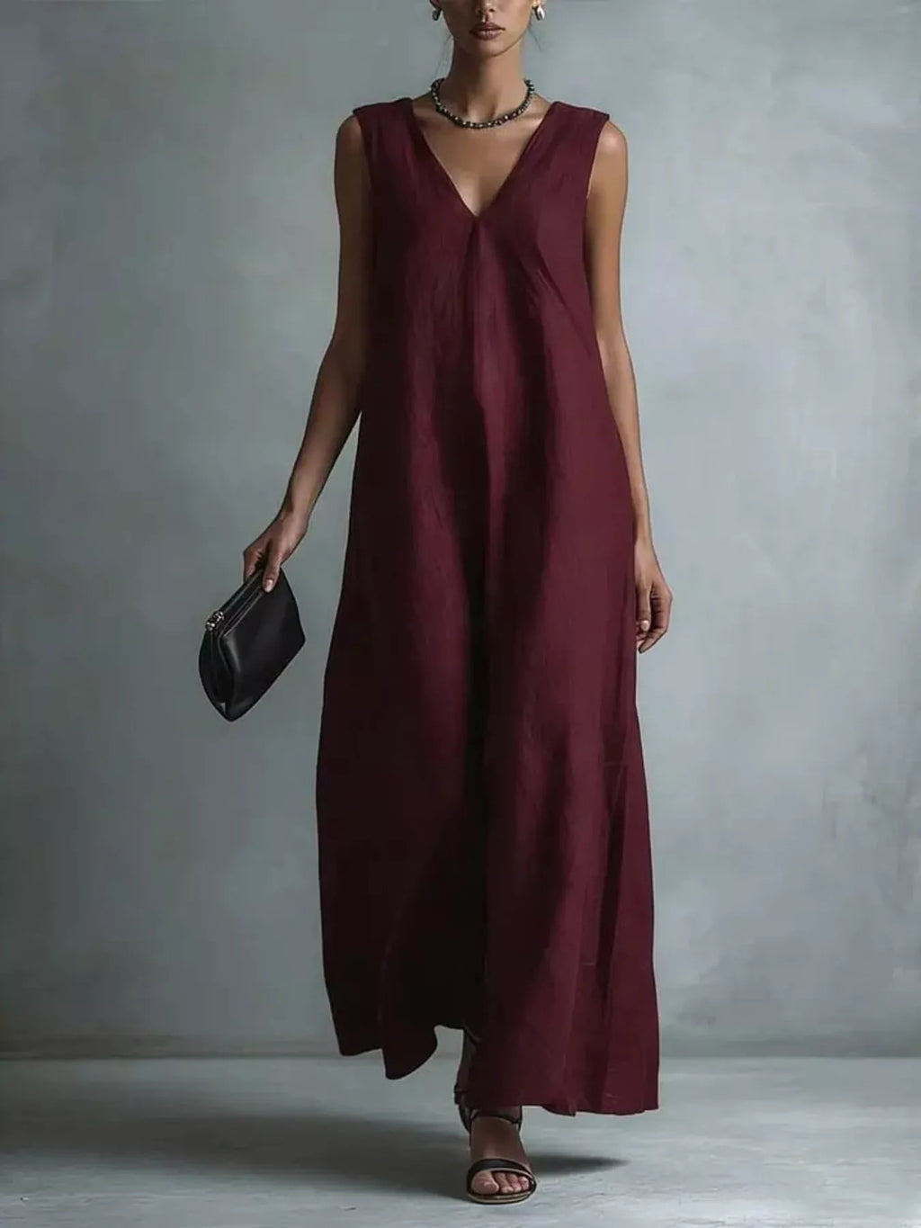 Plus size full-length V-neck sleeveless maxi dress by Trendsi, flowing fabric and elegant design for a stylish summer look.
