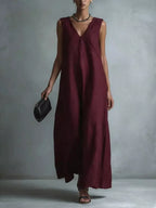 Plus size full-length V-neck sleeveless maxi dress by Trendsi, flowing fabric and elegant design for a stylish summer look.