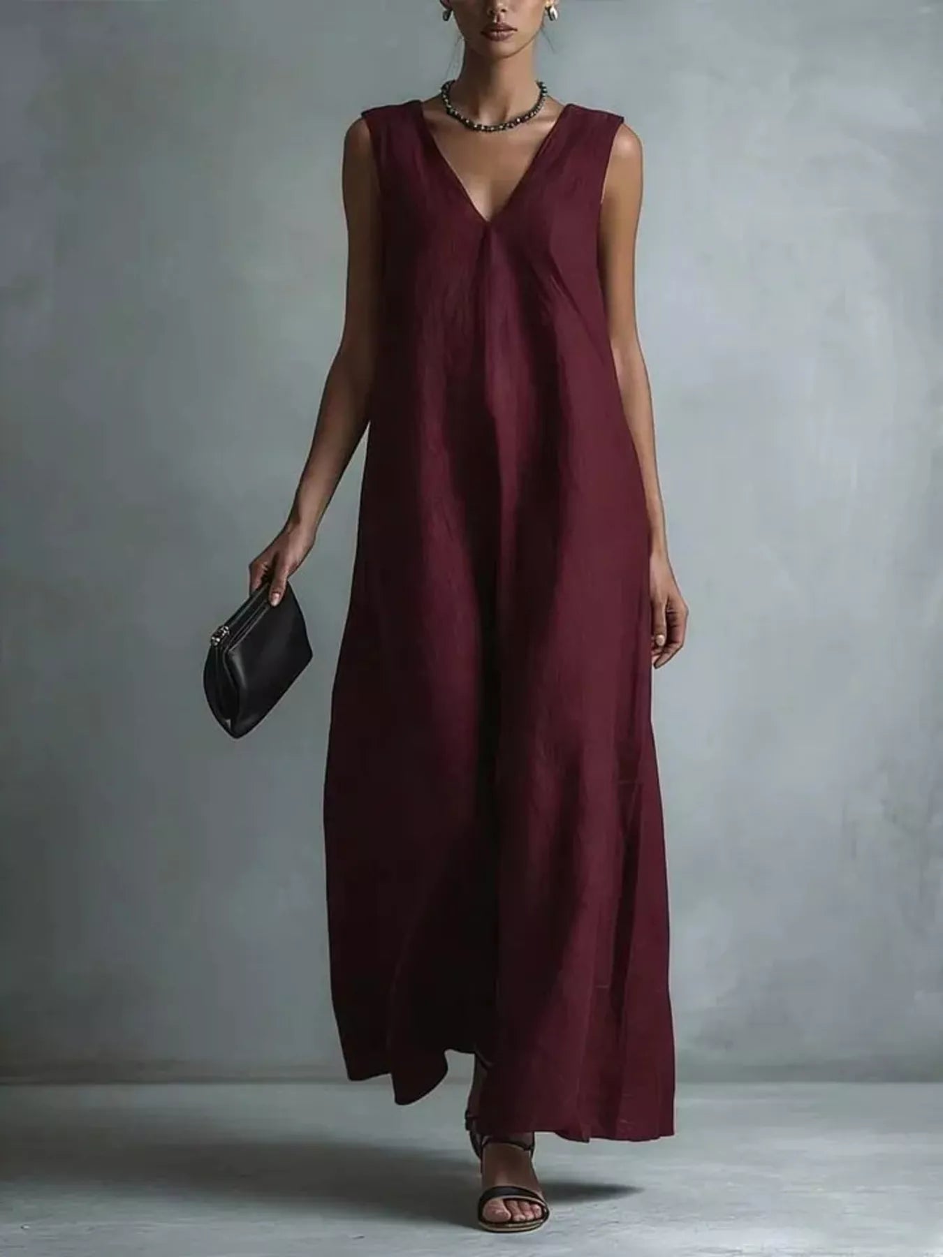 Plus size full-length V-neck sleeveless maxi dress by Trendsi, flowing fabric and elegant design for a stylish summer look.