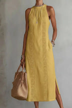 Plush Fashion Hub women's sleeveless side slit maxi dress with pockets, flowing fabric and a stylish slit detail.