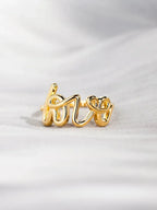 Love 18K gold-plated sterling silver ring with intricate design, showcasing craftsmanship and shiny finish.