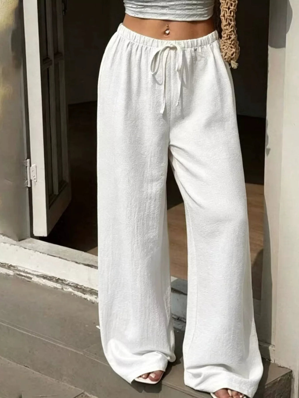 Plus size high-waisted wide-leg pants by Shopimist, showcasing a flowy fit and comfortable waistband in a neutral color.