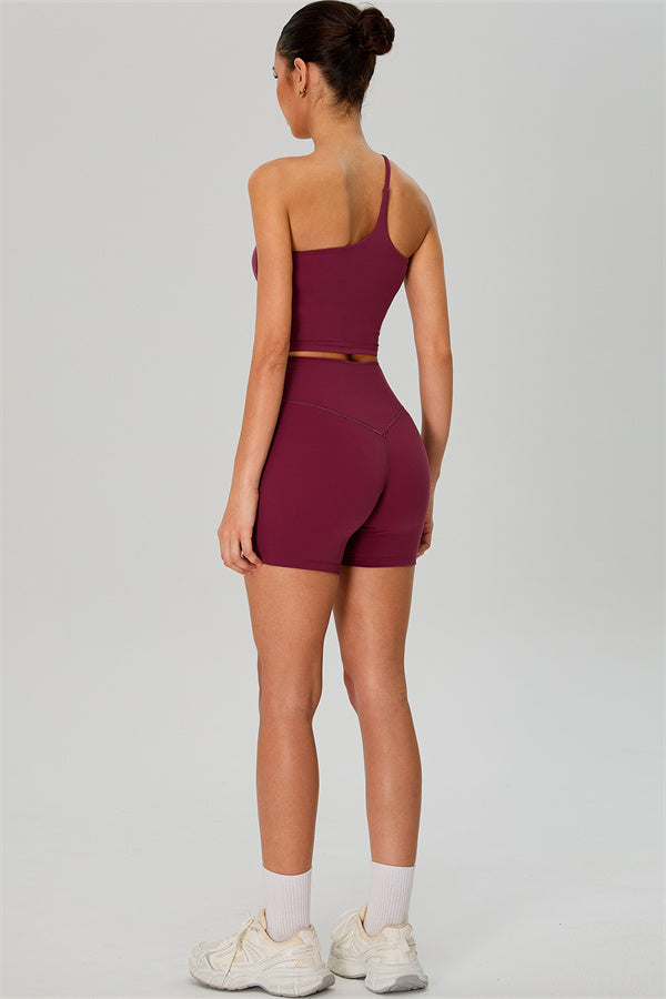 Fitglutes activewear one-shoulder crop top and shorts 2-piece set, stylish gym and workout sportswear for women.