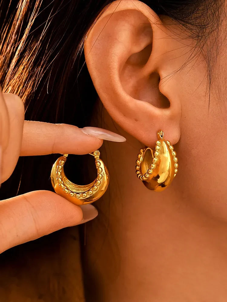 18K gold-plated stainless steel huggie earrings with sleek, minimalist design and secure clasp, perfect for everyday wear.