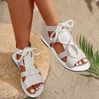 Open toe flats sandals by Shopimist featuring tan straps and a cushioned insole for comfortable everyday wear.