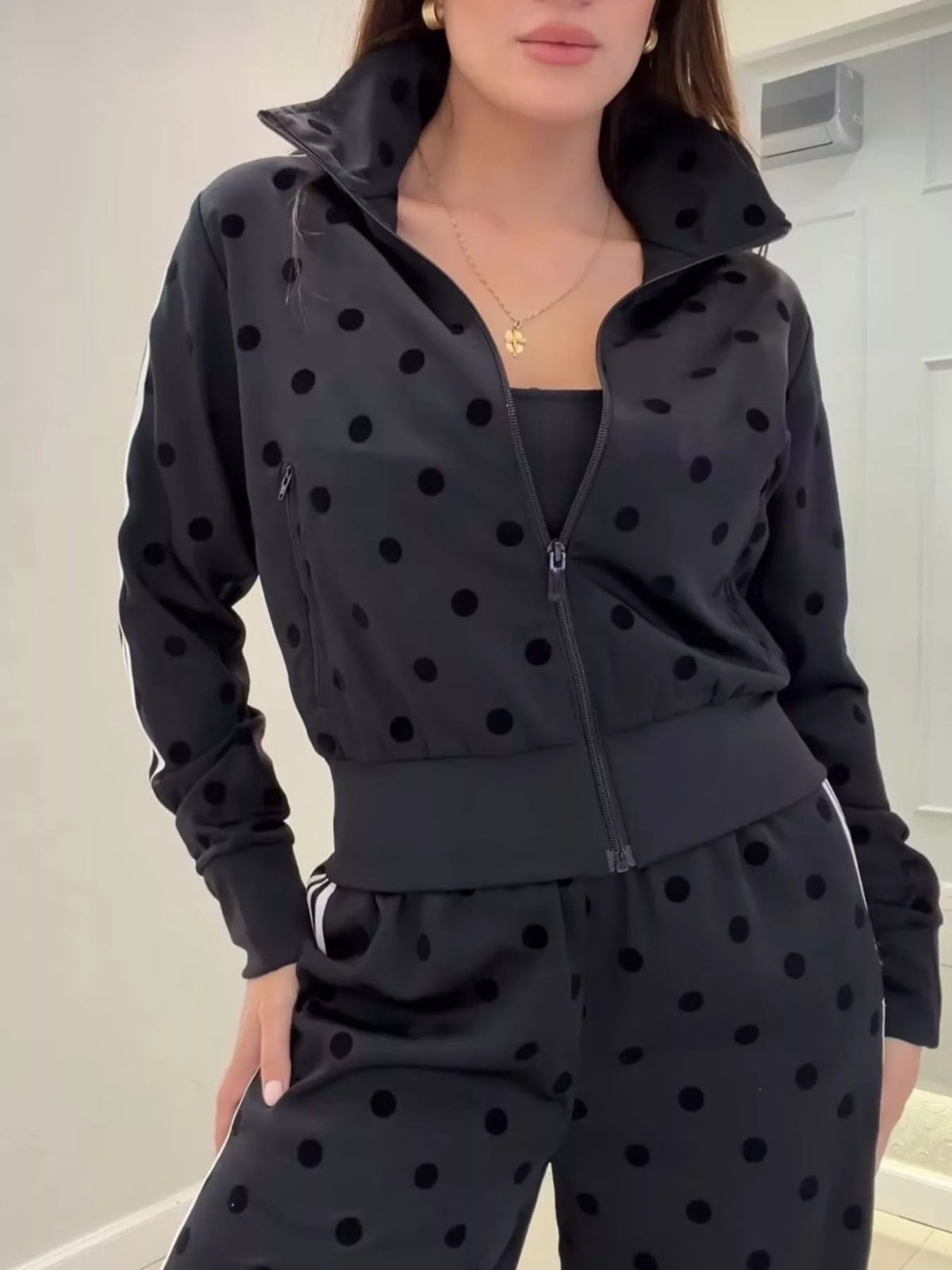 Polka dot zip-up outerwear and pants set by Plush Fashion Hub featuring a matching polka dot design and comfortable fit.