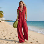 Women's linen-look sleeveless jumpsuit by FitiqueFit with loose fit and pockets, displayed on a hanger against a neutral background.