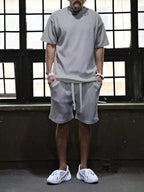 Men's plus size short sleeve top and shorts set from Trendsi, casual summer clothing, black color, front view.