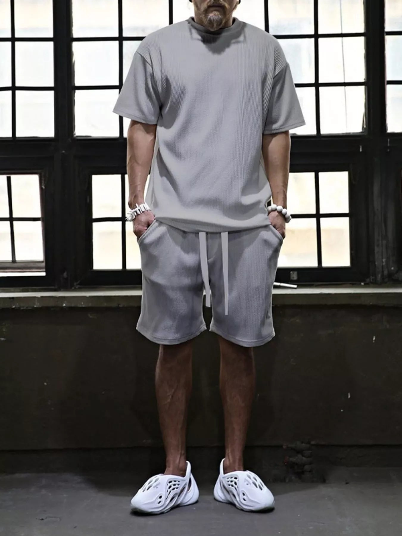 Men's plus size short sleeve top and shorts set from Trendsi, casual summer clothing, black color, front view.