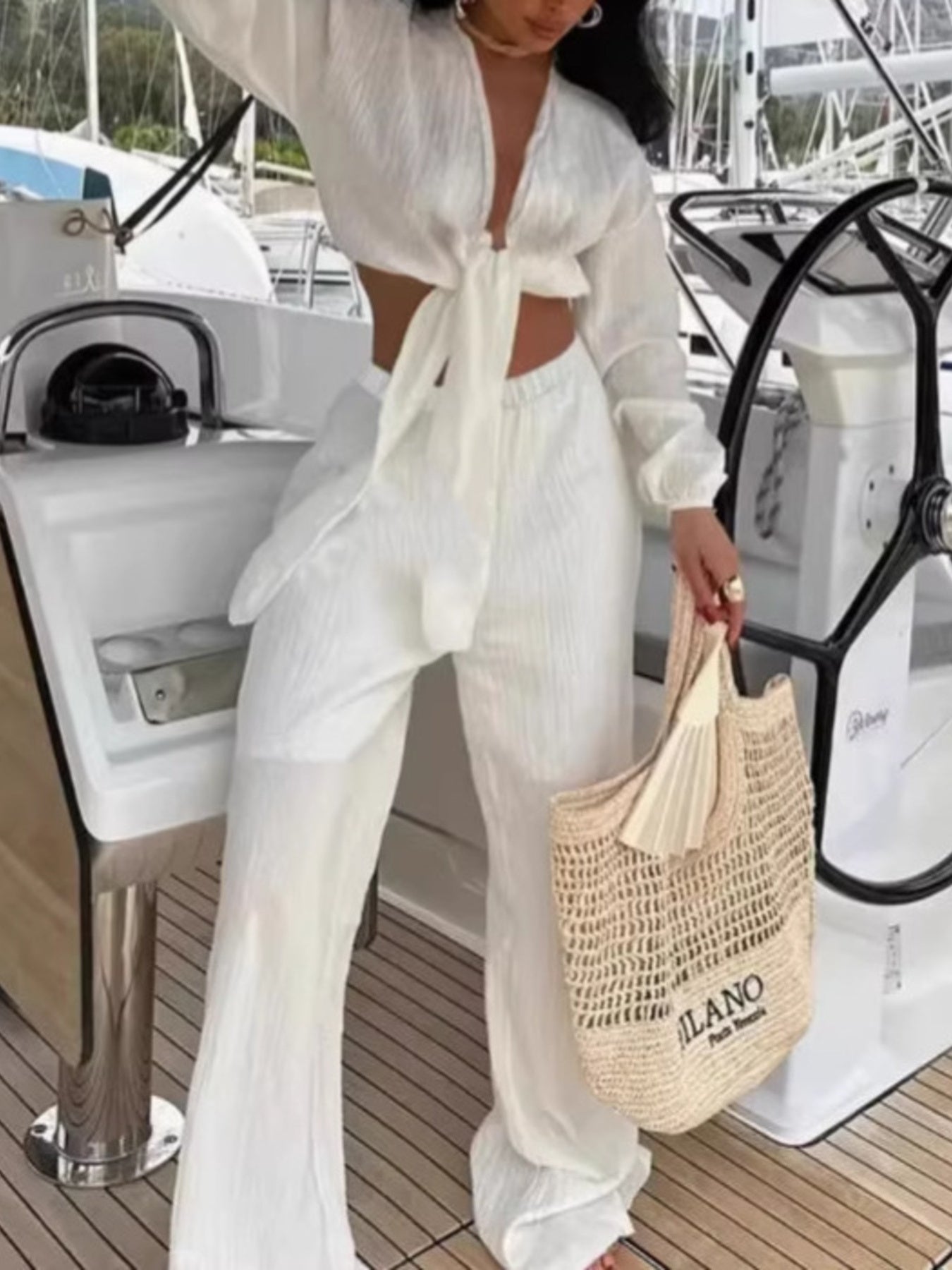 Textured tie-front crop top and wide-leg pants set from Plush Fashion Hub, featuring a stylish two-piece outfit on a model.